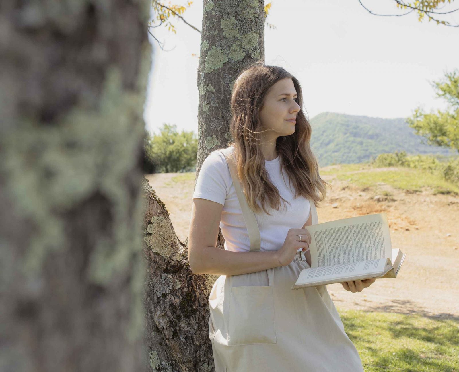 woman reading alone in the park to illustrate books we can read for human connection