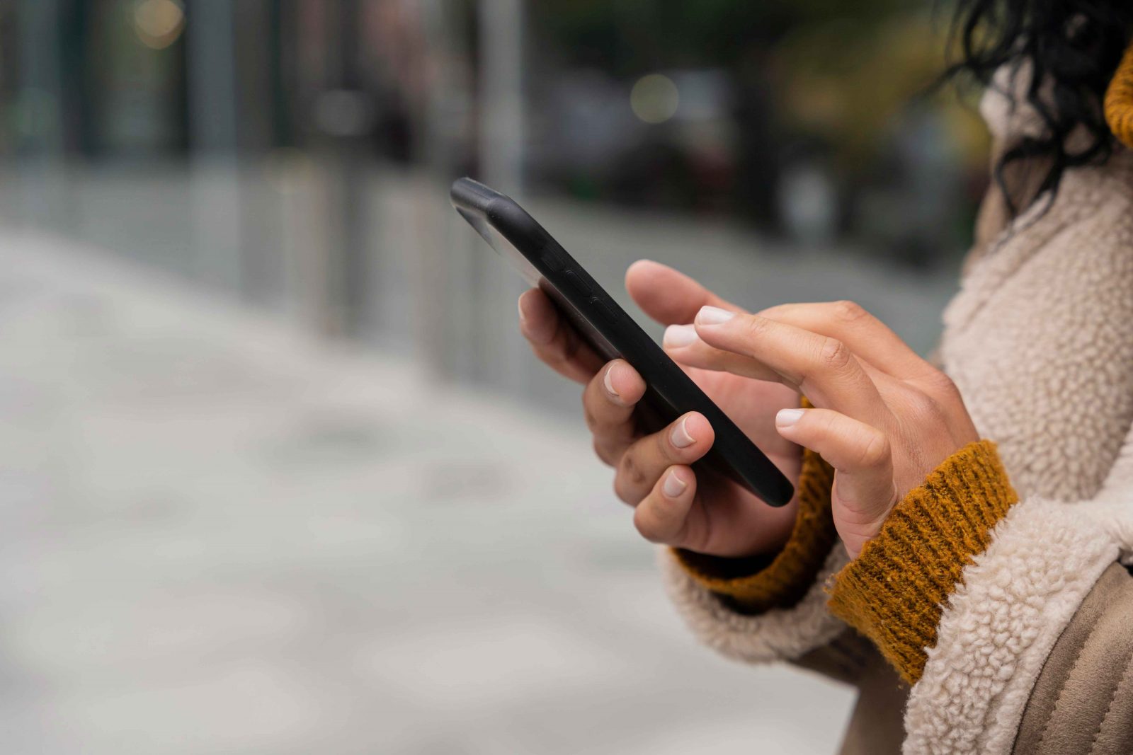 woman holding her phone to illustrate social media and setting healthy boundaries