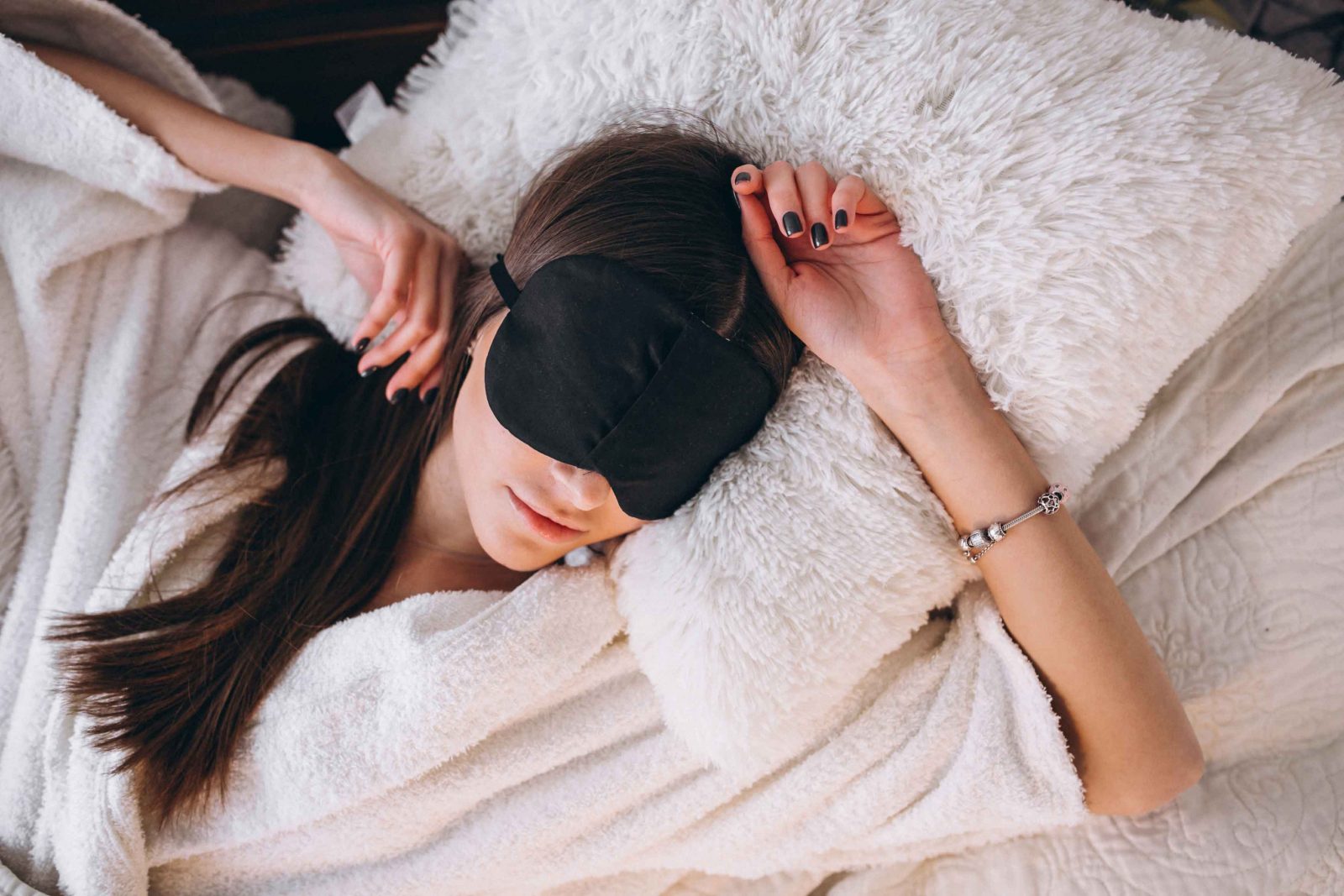 woman sleeping with a sleep mask to illustrate products for good nights rest and sleep