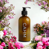 CAHM Oriental Blossom Hand & Body Lotion surrounded by flowers