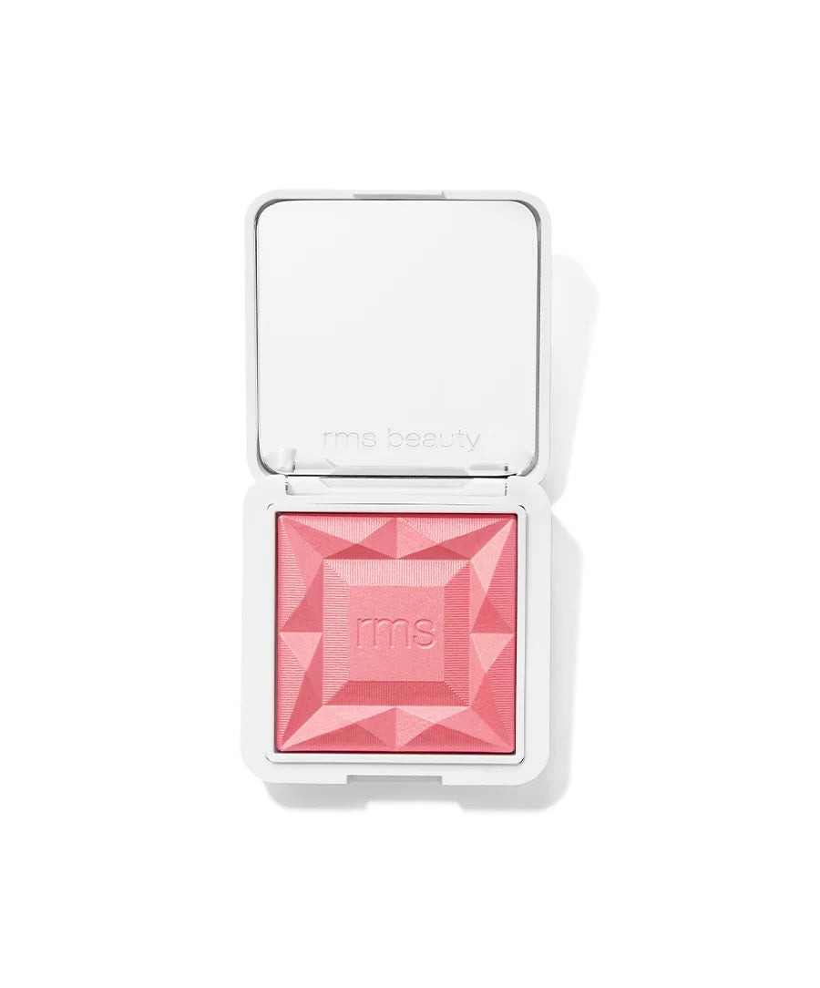 An open RMS Beauty diamond-shaped blush compact showing a vibrant pink pressed powder, set against a clean white background.