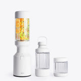 Portable blender with two additional containers on a white background
