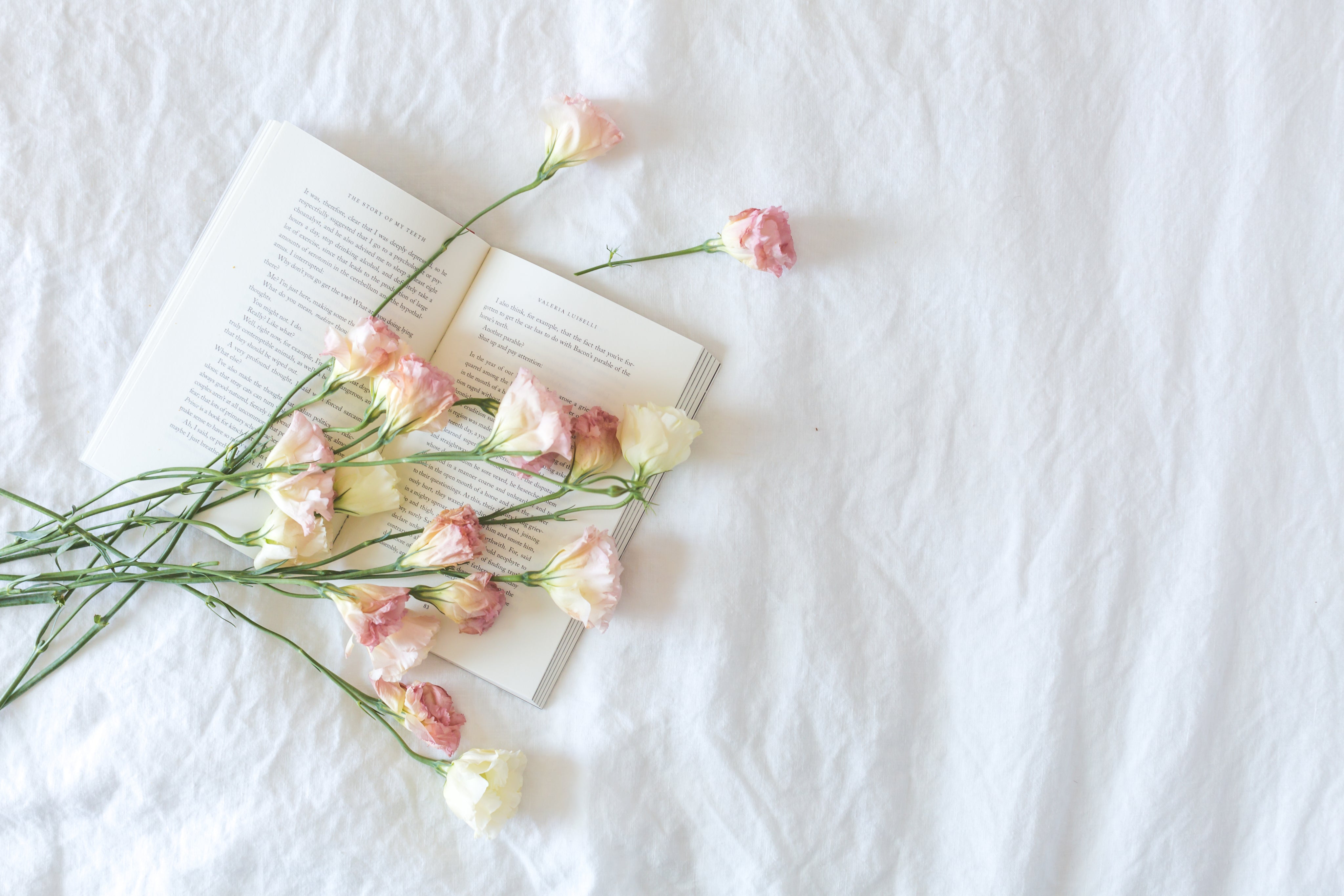 Bed with book and flowers