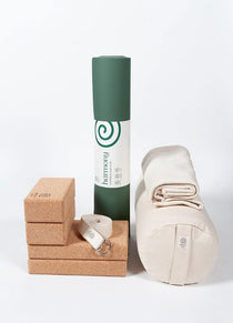 Ekotex yoga accessories including a mat, block, strap and bag on a white background