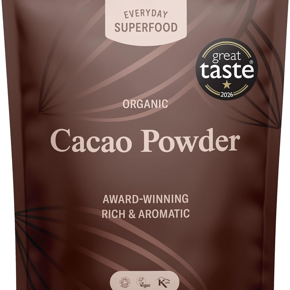 A stand-up pouch of Everyday Superfood Organic Cacao Powder, featuring a dark brown design with light brown leaf patterns and white text, including a 'great taste 2025' award badge.