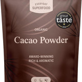 A stand-up pouch of Everyday Superfood Organic Cacao Powder, featuring a dark brown design with light brown leaf patterns and white text, including a 'great taste 2025' award badge.