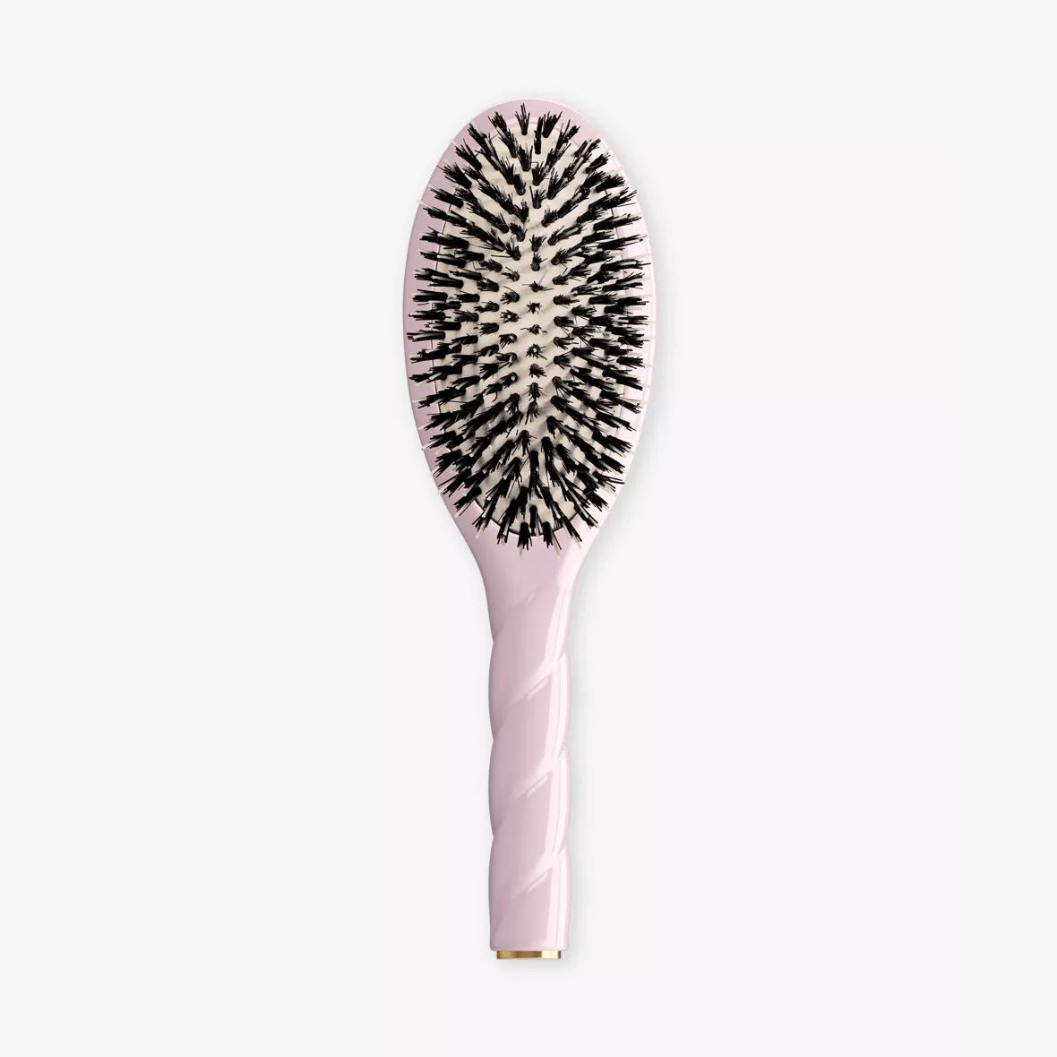 A light pink oval hairbrush with black bristles, shown vertically against a plain white background.