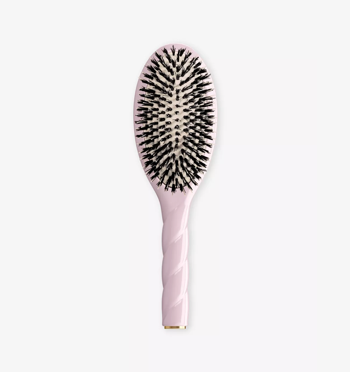 A light pink oval hairbrush with black bristles, shown vertically against a plain white background.