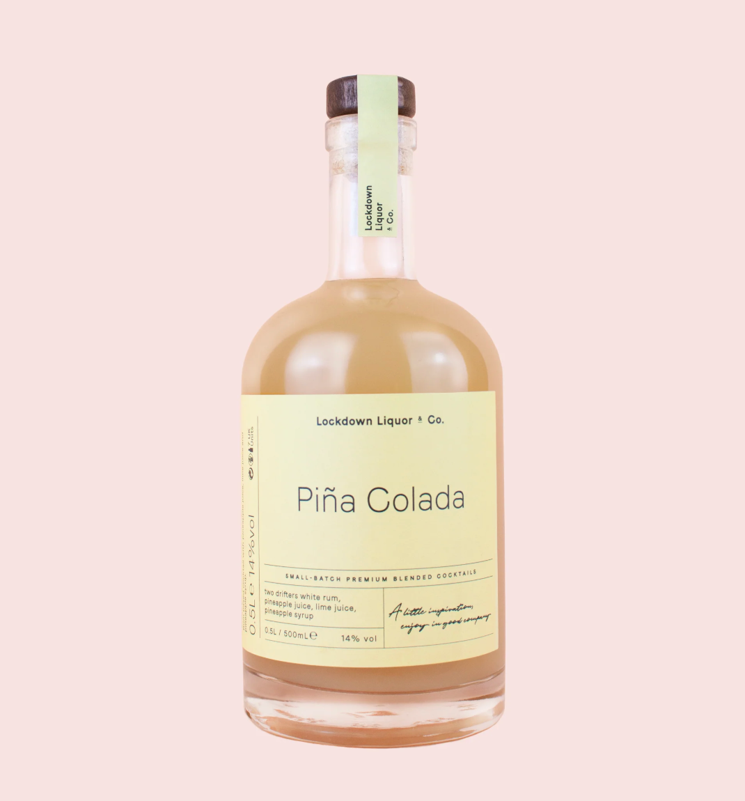 A bottle of Piña Colada by Lockdown Liquor & Co. featuring a pale yellow label and a light green neck seal, filled with a creamy beige liquid, set against a solid pale pink background.