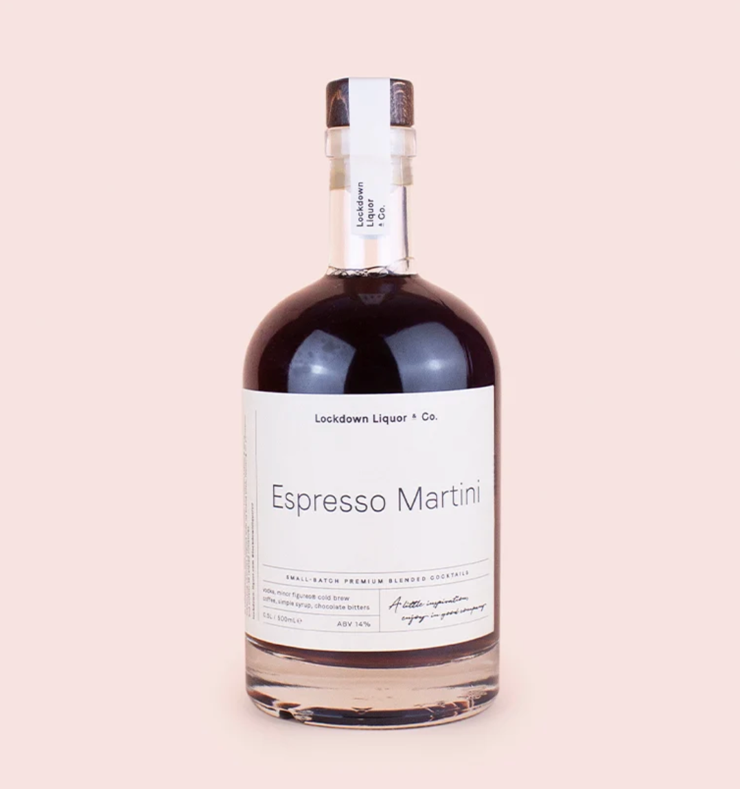A bottle of Lockdown Liqueur Co. Espresso Martini on a solid pale pink background.