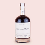 A bottle of Lockdown Liqueur Co. Espresso Martini on a solid pale pink background.