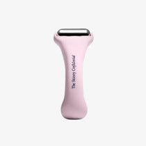 Pink skin care tool with 'The Skinny Confidential' branding on a white background
