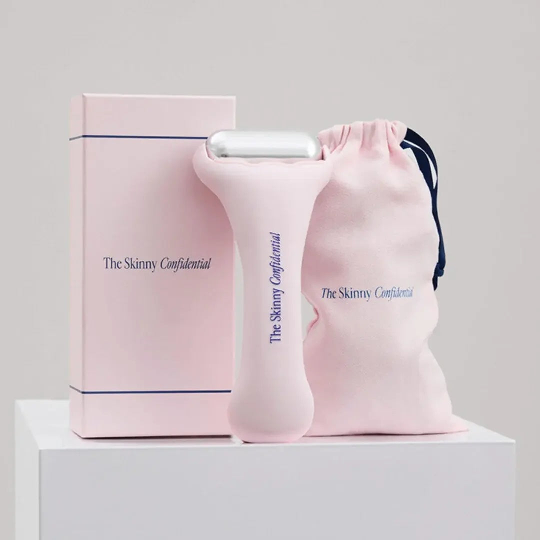 Pink handheld device and drawstring bag with 'The Skinny Confidential' branding on a light gray background.